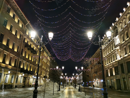 Festive illumination for Christmas and New Year on Malaya Konyushennaya Street in St. Petersburg on an early winter morning photo