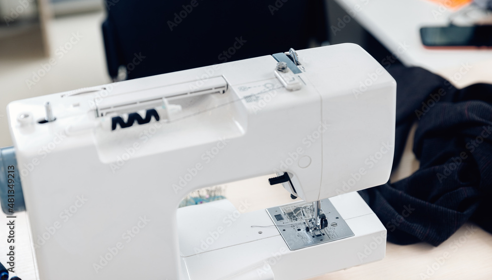 Closeup sewing machine and needles, Workplace for tailor seamstress, sunlight background
