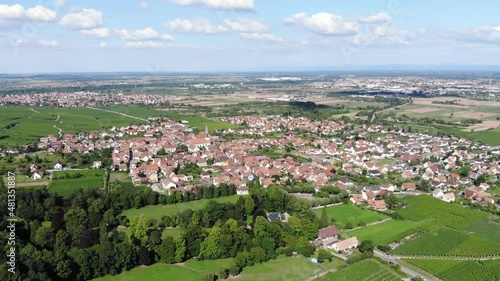 General view of Kintzheim town from air, famous old village at Bas-Rhin, France, located near Selestat and part of Alsace Wine route. Panoramic aerial shot of village at sunny summer day photo