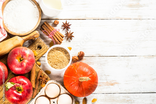 Fall baking. Autumn baking concept. Ingredients for baking - flour  sugar  apples and spices. Top view at white wooden table.