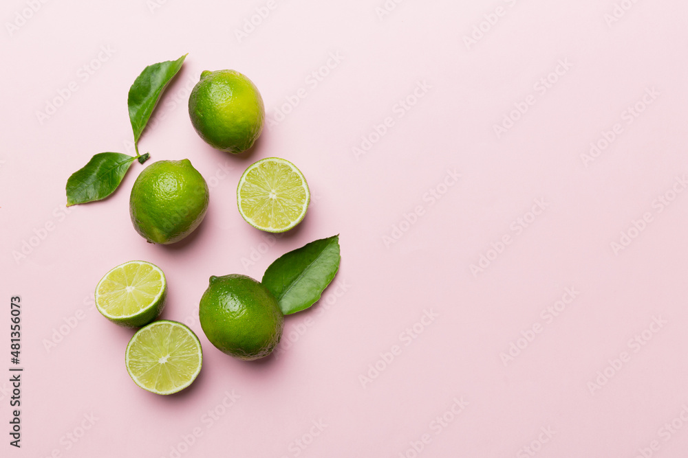 Lime fruits with green leaf and cut in half slice isolated on white background. Top view. Flat lay with copy space Lime fruits with green leaf and cut in half slice isolated on white background. Top view. Flat lay with copy space