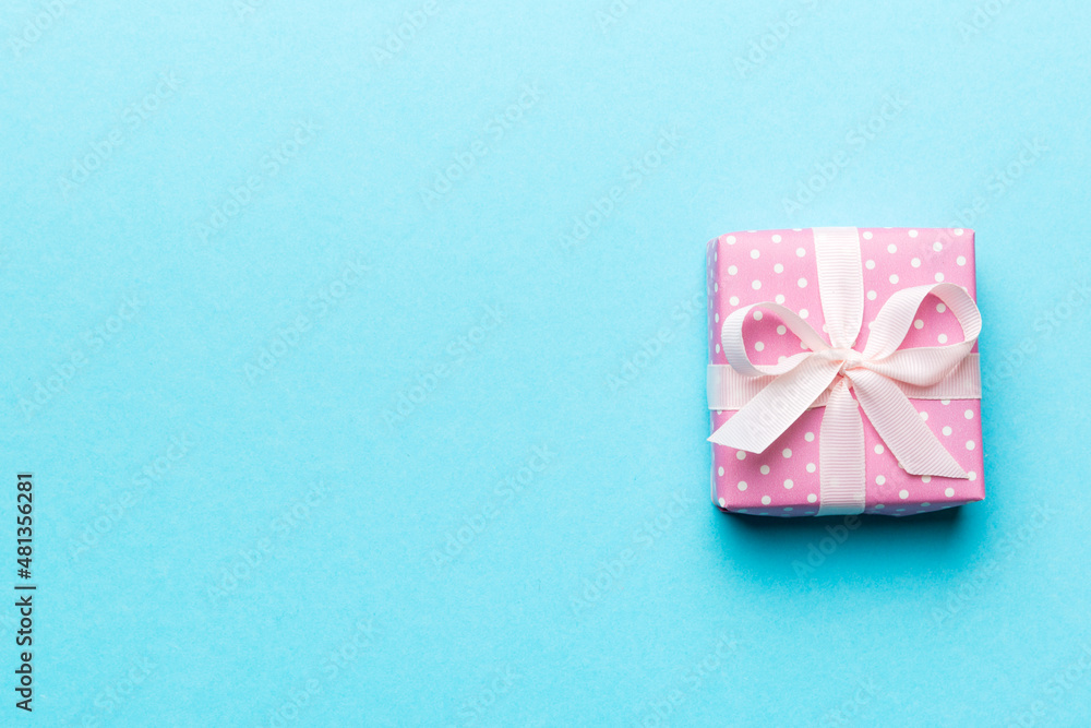 Valentine day composition: red gift box with bow and heart. Christmas present. View from above. Space for text. Holday greeting card Valentine day composition: red gift box with bow and heart. Christmas present. View from above. Space for text. Holday greeting card