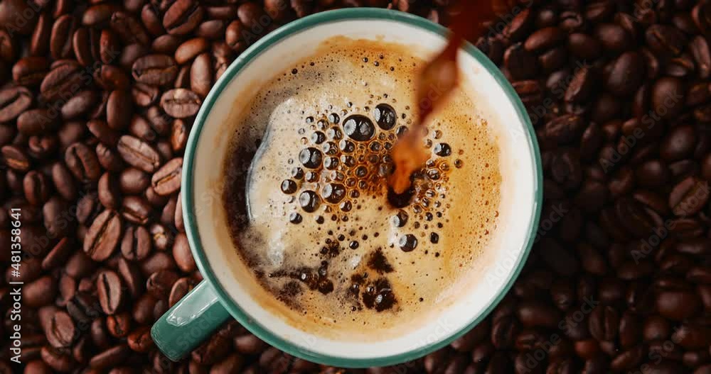 brewed coffee in a geyser coffee maker is poured into a coffee mug, top view, slow motion