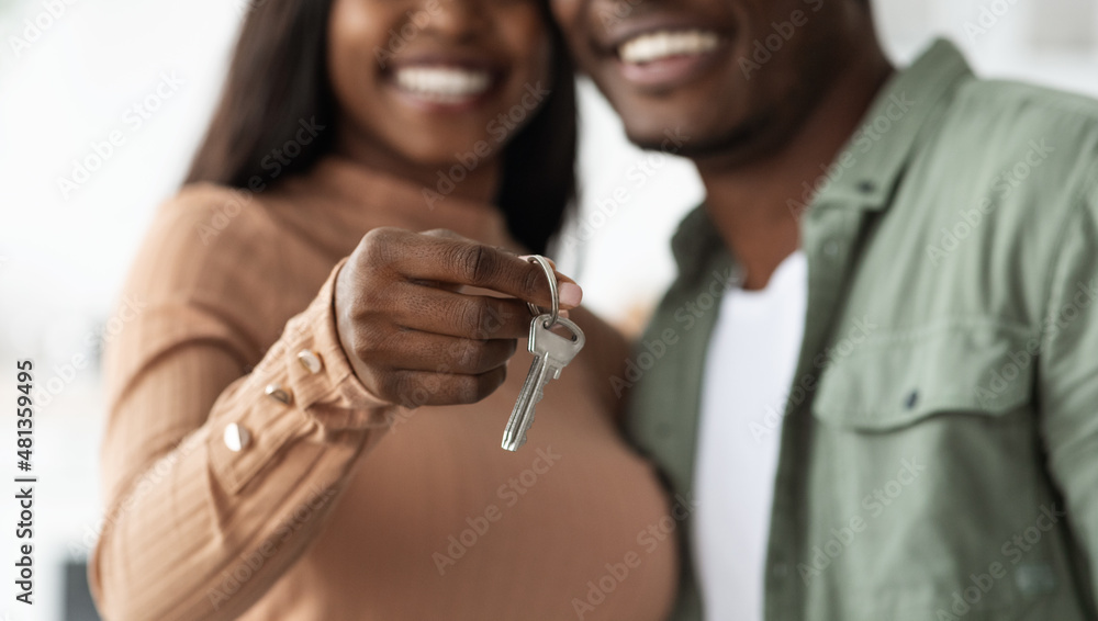 Unrecognizable black couple showing key from apartment