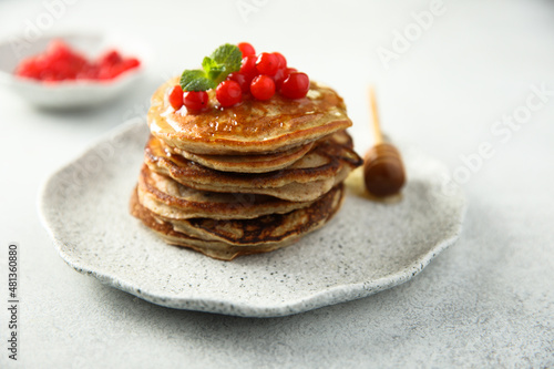 Homemade pancakes with berries and honey