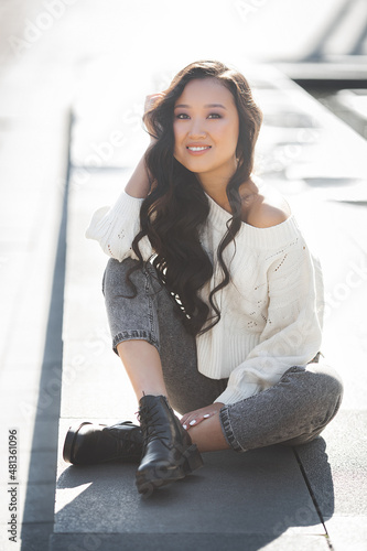 Beautiful woman outdoors. Pretty lady on urban background. Asian female closeup portrait.