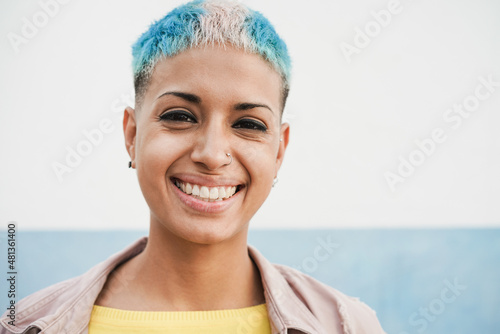 Portrait of hispanic gay woman looking at camera - Focus on face