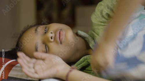 Girl kid not able to sleep during night - concept of insomnia, sleeping disorder and loneliness