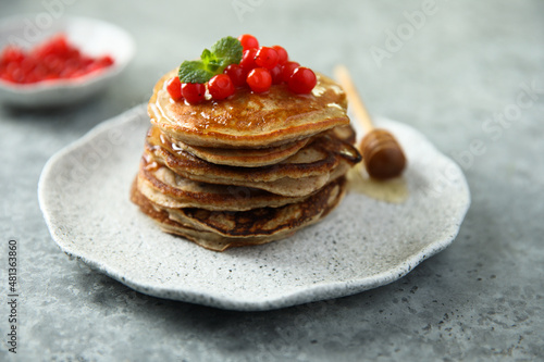 Homemade pancakes with berries and honey