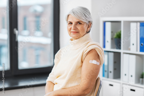 medicine, health and vaccination concept - vaccinated senior woman with medical patch on arm at hospital Free Download medicine, health and vaccination concept - vaccinated senior woman with medical patch on arm at hospital - GFXLoad