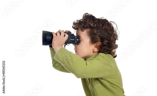 Profile of a little boy looking through the binoculars