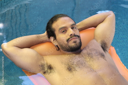 Very sensual ethnic man sunbathing in swimming pool  © ajr_images