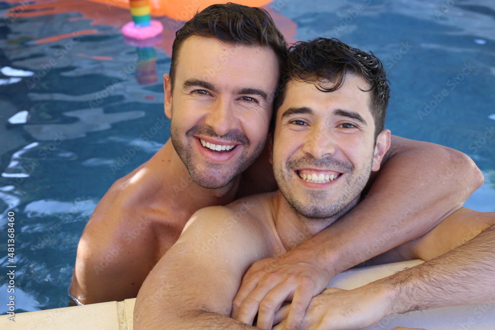 Handsome gay couple in swimming pool Handsome gay couple in swimming pool