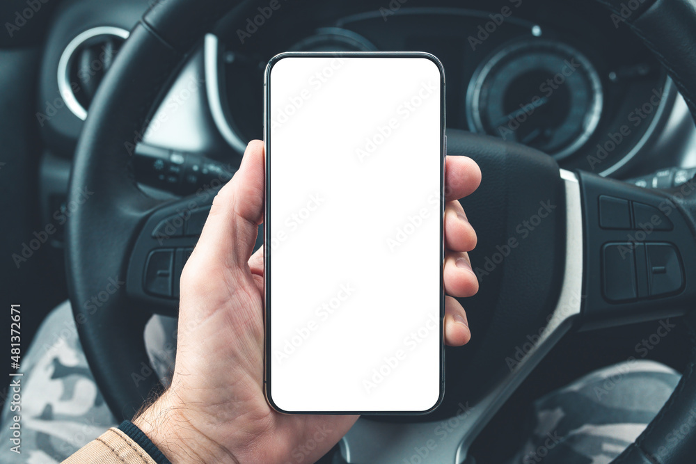 Smartphone mockup in male driver hand over car steering wheel