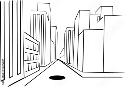 The city street is surrounded on both sides by buildings and in the middle there is a sewage drain
