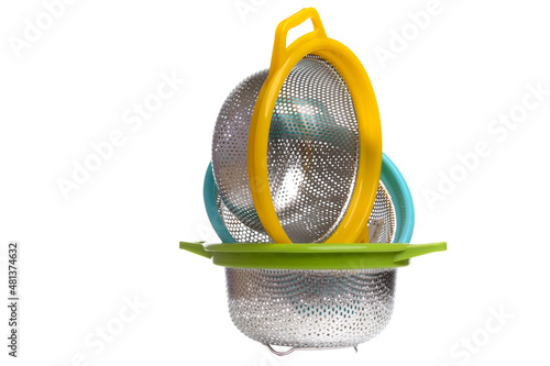 set of multi-colored aluminum colanders on a white isolated background