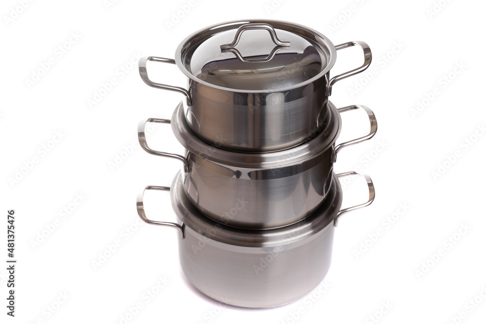 a set of three homemade stylish kitchen pots standing on top of each other made of polished metal with thin handles and a glass lid on a white isolated background a set of three homemade stylish kitchen pots standing on top of each other made of polished metal with thin handles and a glass lid on a white isolated background