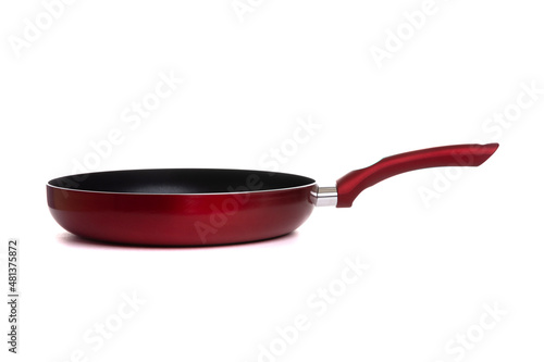 homemade large dark red non-stick frying pan with red handle on a white background