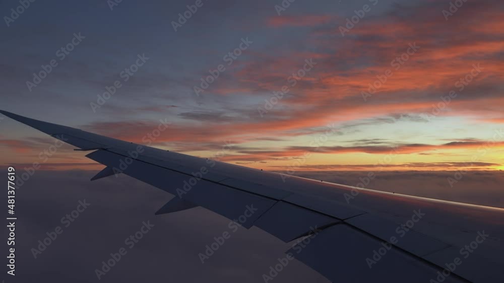 Airplane flight. Wing of an airplane flying close to the clouds with scenic sunset sky. View from the window of the plane. Airplane, Aircraft. Beautiful scenic sky panorama. Traveling by air Airplane flight. Wing of an airplane flying close to the clouds with scenic sunset sky. View from the window of the plane. Airplane, Aircraft. Beautiful scenic sky panorama. Traveling by air