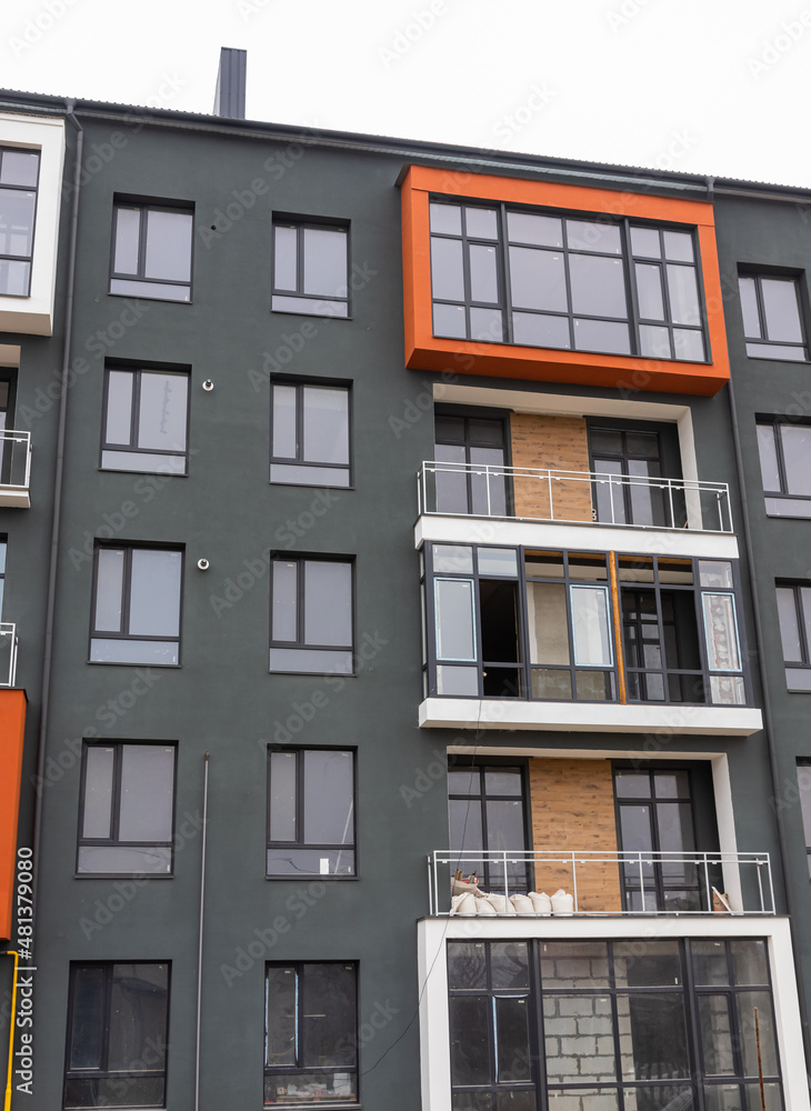 Obraz premium Fragment of Modern residential apartment with flat buildings exterior. Detail of New luxury house and home complex. Part of City Real estate property and condo architecture. Copy space