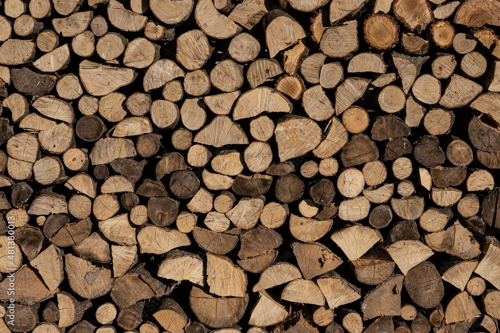 Pile of stacked triangle firewood prepared for fireplace and boiler Pile of stacked triangle firewood prepared for fireplace and boiler