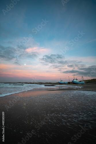 Beach of norre vorupor, denmark, sunset over old fishing boats photo