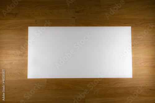 White sheet of paper on wooden background