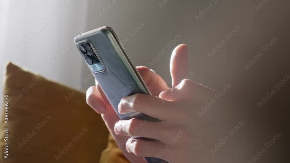 Man using smartphone at home, soft light. Man using smartphone at home, soft light.