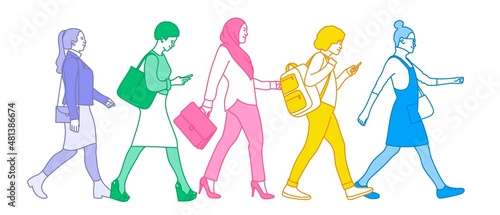 Women of different nationalities and cultures walk through the city.