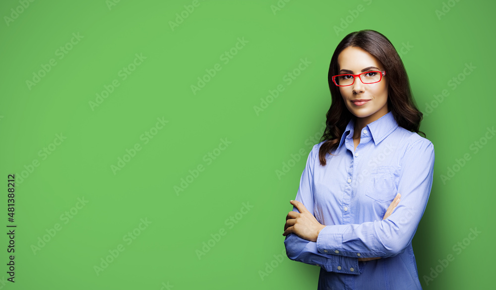 Portrait of seriously looking businesswoman in eye glasses spectacles. Image of brunette young business woman at studio, isolated on green color background. Portrait of seriously looking businesswoman in eye glasses spectacles. Image of brunette young business woman at studio, isolated on green color background.