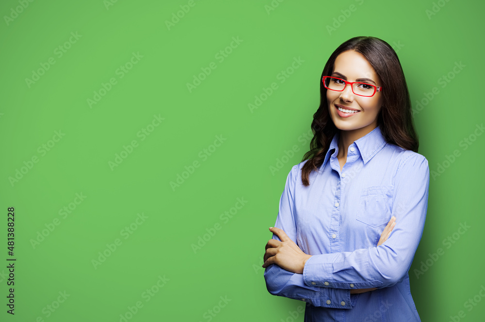 Portrait of cheerfully smiling amazed businesswoman in eye glasses spectacles. Brunette young business woman at studio, isolated on green color background. Portrait of cheerfully smiling amazed businesswoman in eye glasses spectacles. Brunette young business woman at studio, isolated on green color background.
