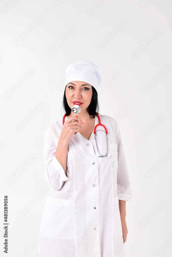 A female therapist with a stethoscope as if with a microphone in the clinic on a white background A female therapist with a stethoscope as if with a microphone in the clinic on a white background