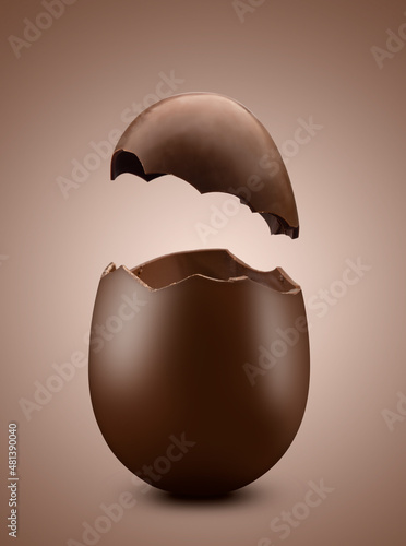 Broken chocolate easter egg on brown background
