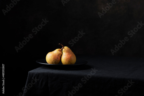 Fresh sweet pears on the dark background