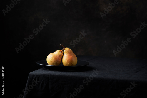 Fresh sweet pears on the dark background