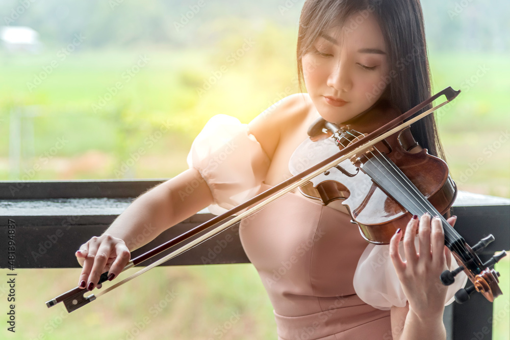 Beautiful woman hold violin on nature view background, in emotion feeling happy. Beautiful woman hold violin on nature view background, in emotion feeling happy.
