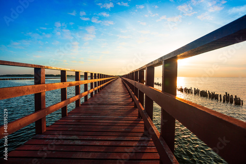Fototapeta Naklejka Na Ścianę i Meble -  Sunrise and beautiful sky background at wooden red bridge over the sea at Gulf of Thailand, near by Tha Chin estuary, Samutsakhon province, Thailand 