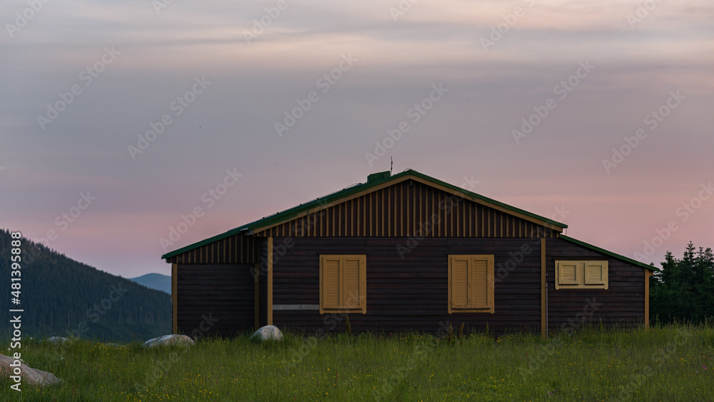 barn in the sunset in the mountains