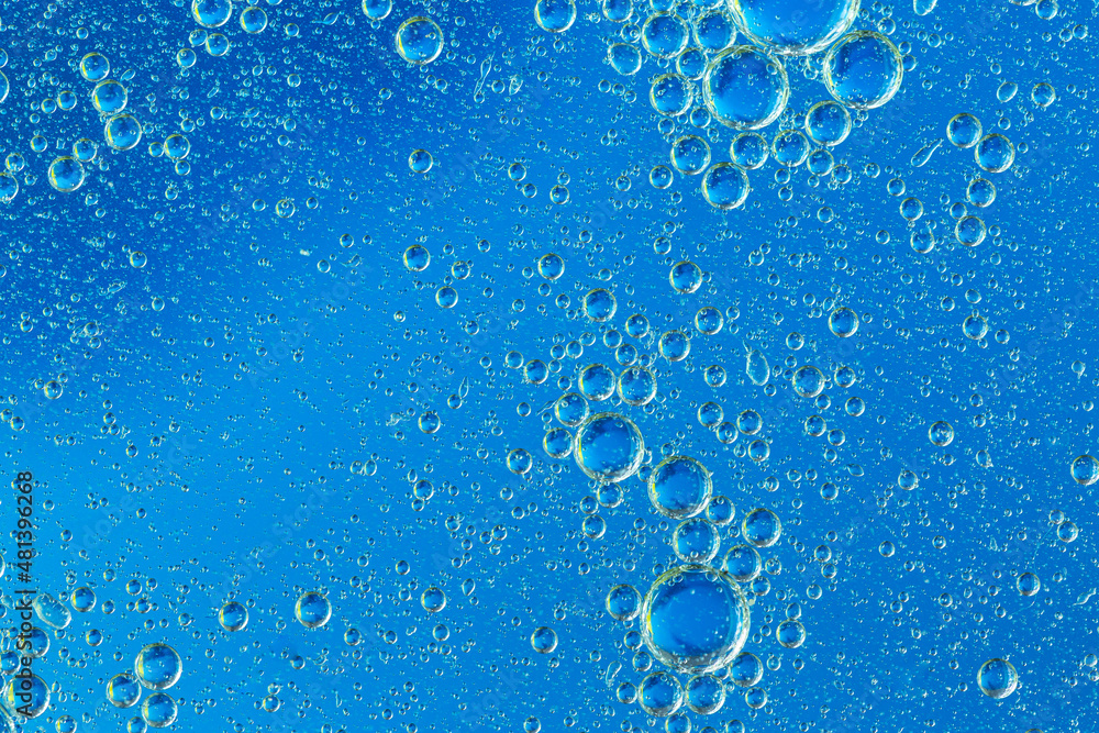Blue macro bubbles,Colorful artistic of oil drop floating on the water