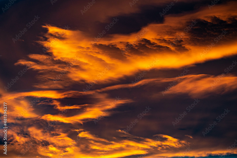 a landscape close up image of golden orange clouds during a sunset over the Mediterranean wallpaper background