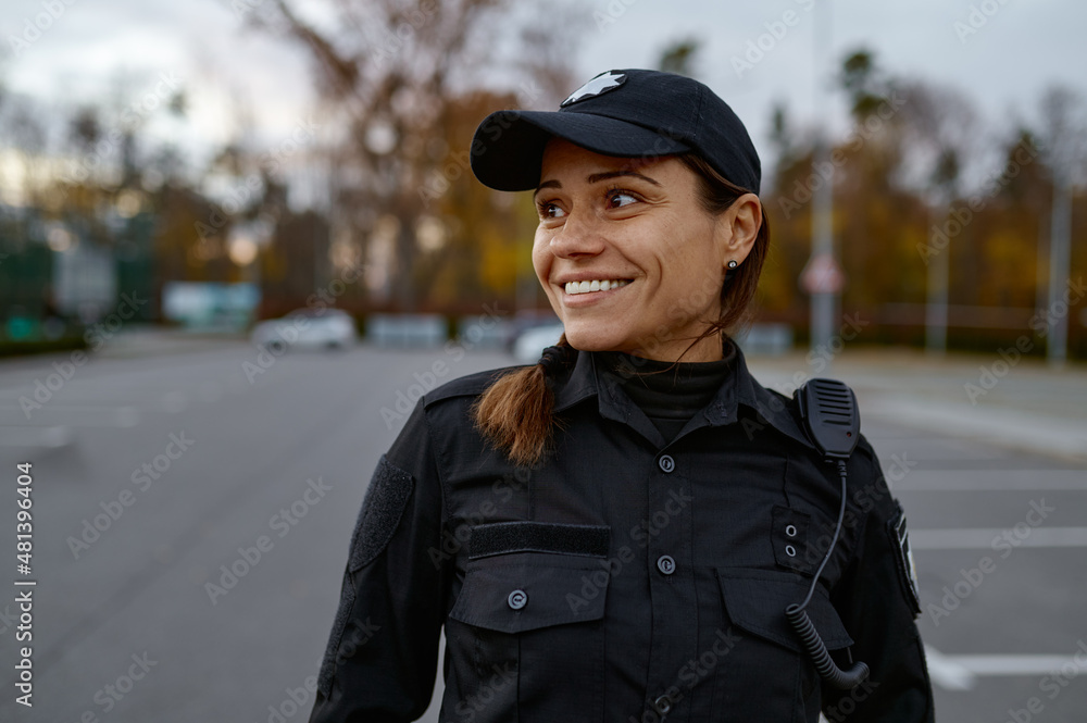 Portrait of smiling police woman on street