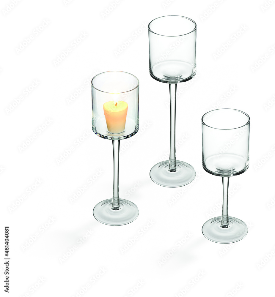 Set of three glass candlestick holders, with a lit candle, isolated Set of three glass candlestick holders, with a lit candle, isolated