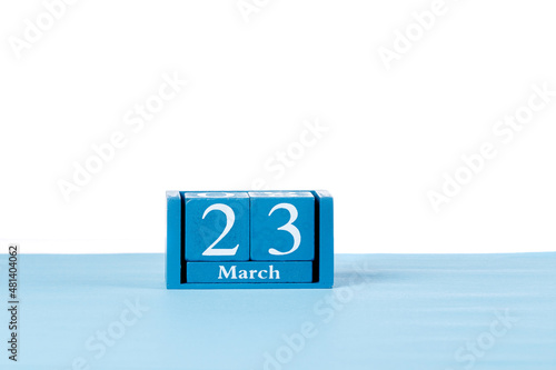 Wooden calendar March 23 on a white background