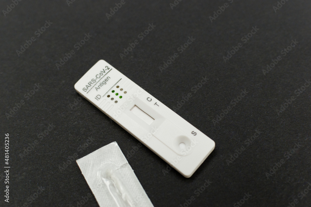 Corona rapid antigen test and swab stick on black background Corona rapid antigen test and swab stick on black background