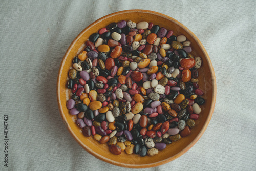 Multi color bean grains on white background and rustic plating
