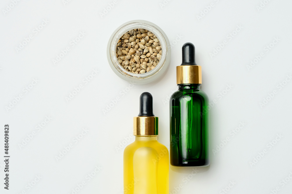 Marijuana cosmetic products, CBD oil. Medicinal hemp extract in cosmetic bottles on white background. Natural herbal care, medical usage, cannabis therapy. Marijuana cosmetic products, CBD oil. Medicinal hemp extract in cosmetic bottles on white background. Natural herbal care, medical usage, cannabis therapy.