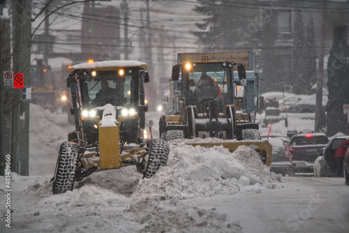 Snow removal crews cleaning city streets.