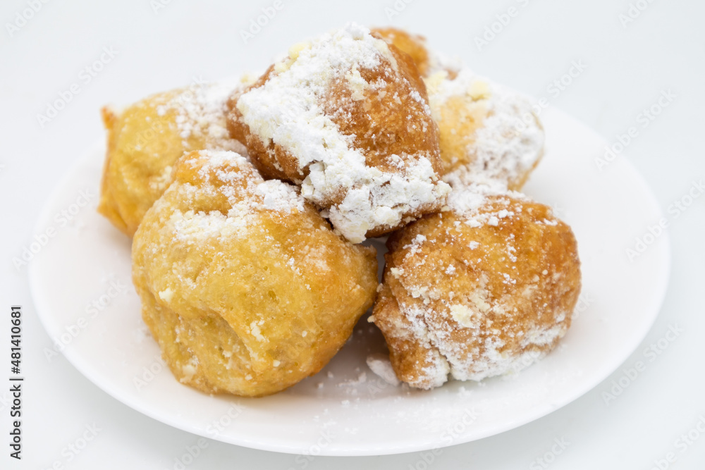 Italian Zeppole Donuts with Powdered Sugar on a White Plate