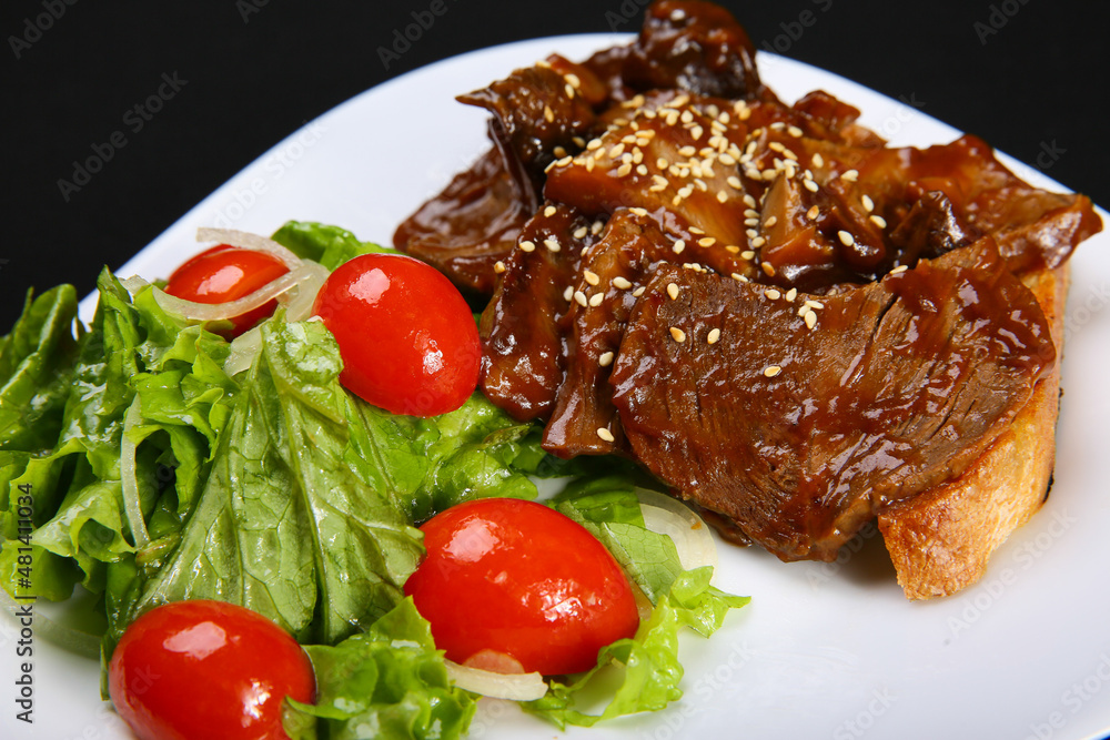 Steak. Beef on toast with demiglace sauce. close-up Steak. Beef on toast with demiglace sauce. close-up