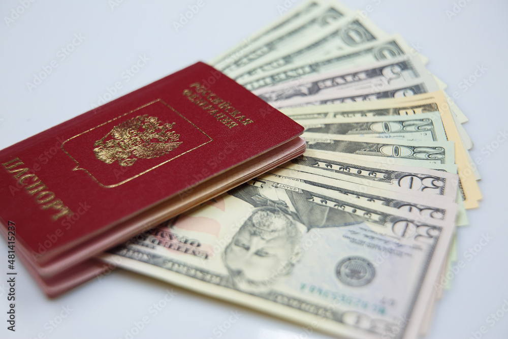 Passport and dollar bills Travel, change of citizenship, the concept of labor migration Passport and dollar bills Travel, change of citizenship, the concept of labor migration